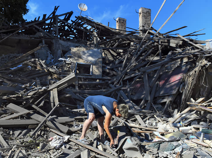 Донецк. Жительница города на развалинах дома, разрушенного в результате обстрела