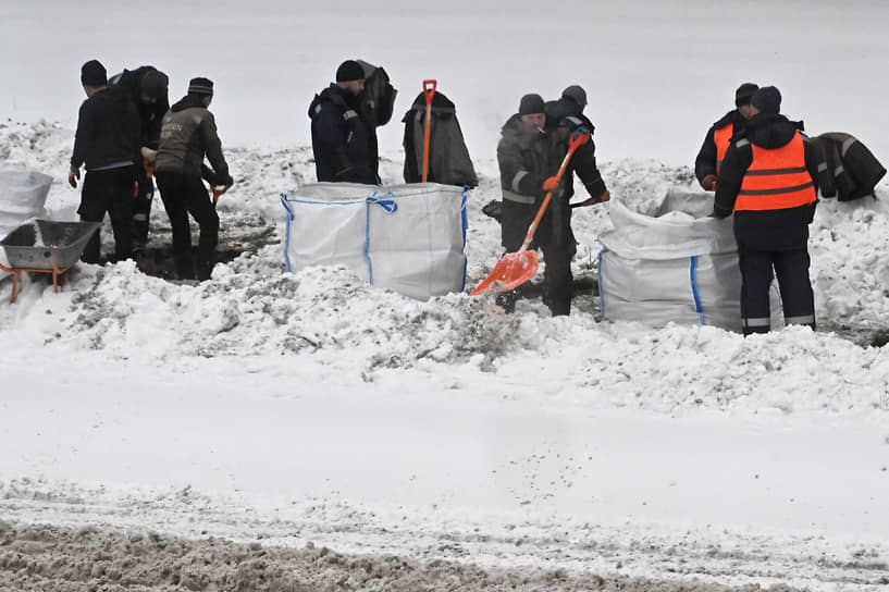 Сотрудники коммунальной службы убирают снег