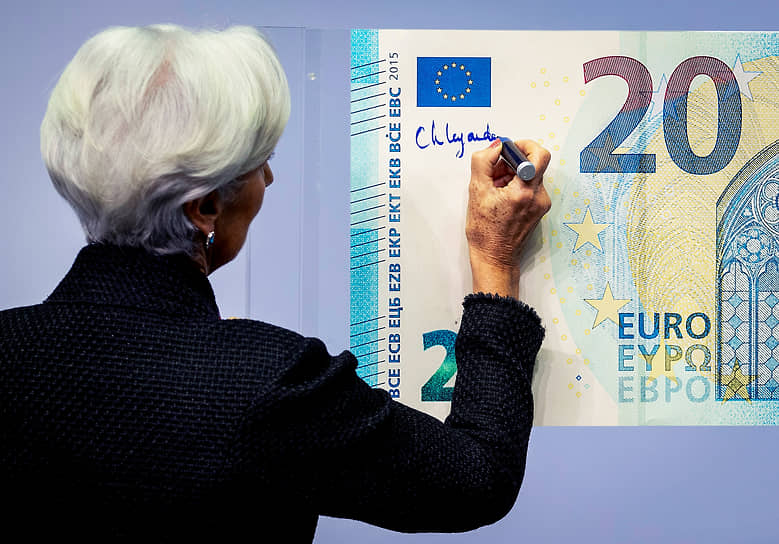 Председатель Европейского центрального банка Кристин Лагард ставит свою подпись на банкноте после избрания на должность