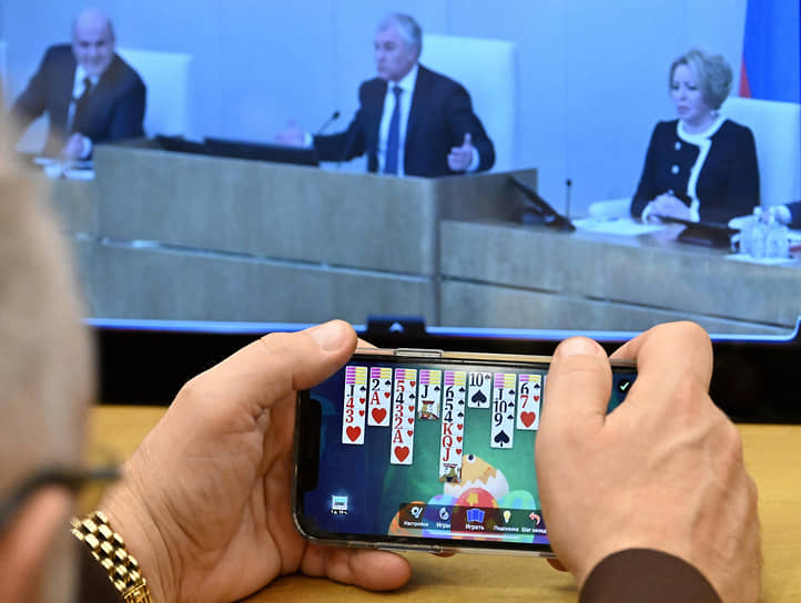 Депутат раскладывает пасьянс на мобильном телефоне во время заседания