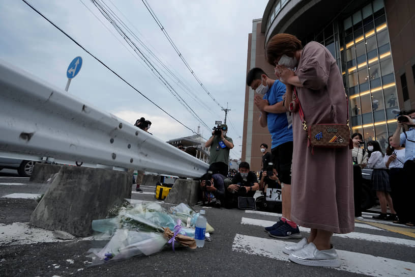 Люди молятся у импровизированного мемориала на месте стрельбы в Синдзо Абэ