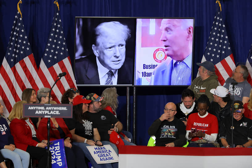 На мониторе слева направо: Дональд Трамп и Джо Байден