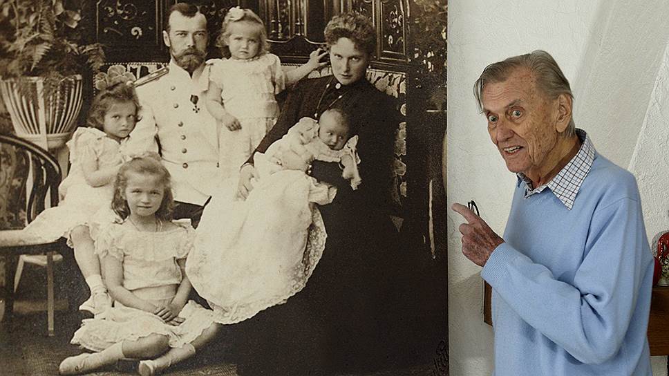 Князь Николай Романов перед увеличенным семейным фото царской семьи
