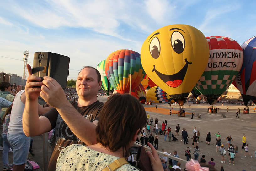 Зрители фотографируются на фоне шаров
