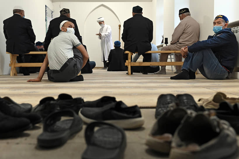 Мусульмане в медицинских масках молятся в мечети во время празднования Ураза-байрам