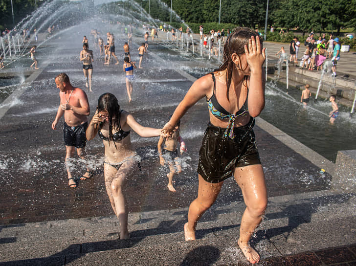 Жители купаются в фонтане Парка 300-летия Санкт-Петербурга во время жары
