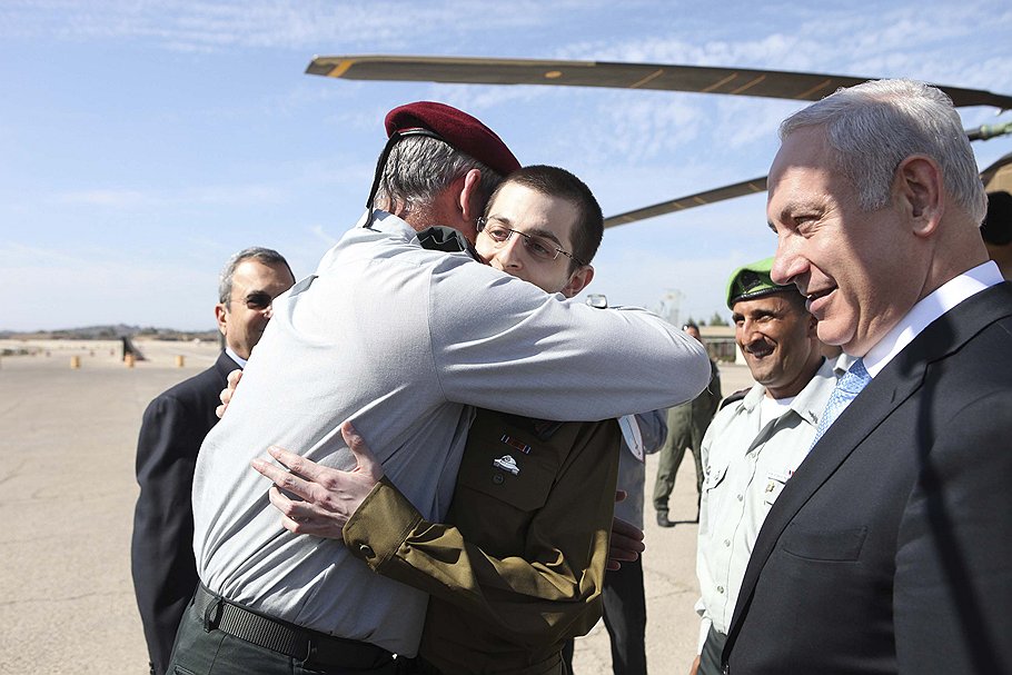 Премьер-министр Израиля Биньямин Нетаньяху (справа) добился освобождения Гилада Шалита (в центре) после долгого и успешного торга 