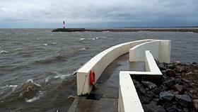 The complex of protective structures in St. Petersburg (dam) during a stormy wind and the threat of flooding - a closed navigational facility on the main ship fairway in the Gulf of Finland.