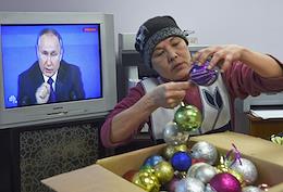 Genre photography. People listen and watch the Big Annual Press Conference of Russian President Vladimir Putin.