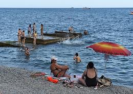 Holiday season in Crimea. Vacationers on the Massandra beach.
